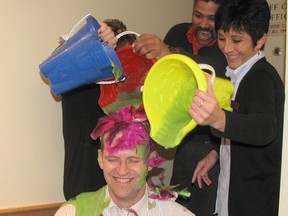 Jeff Dunlop, an auditor with the LCBO, smiles as employees from the Wellington Street Store in Chatham doused him with slime and feathers on Friday. The chance to “slime” an auditor gave the employees some extra incentive to raise money for the United Way of Chatham-Kent. Also pictured are store manager Darren Lopes, back, and Maria Mariconda, right. Anita Van Dongen, was holding the blue pail.