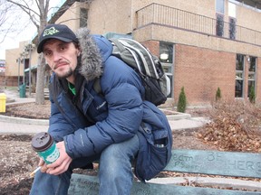 Gene Sterner, 39, sits outside the Sarnia library where he usually comes in from the cold during the daytime. The Sarnia man has had periods of homelessness throughout his entire adult life. He has found temporary refuge on friends' couches, at homeless shelters and even inside donation bins. (BARBARA SIMPSON, The Observer)