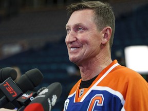 Former captain Wayne Gretzky answers media questions during an Edmonton Oilers media availability with the members of the Stanley Cup winning 83-84 Oilers at Rexall Place in Edmonton, Alta., on Wednesday, Oct. 8, 2014. Players and coaches spoke about the historic win against the New York Islanders, reminisced about the past and had a group photo taken. The 84 reunion event is set for Oct. 10, 2014. Ian Kucerak/Edmonton Sun/ QMI Agency