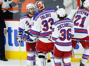 New York Rangers right wing Martin St. Louis (26) congratulates goalie Cam Talbot (33) on a victory against the Philadelphia Flyers at Wells Fargo Center on Nov 28, 2014 in Philadelphia, PA, USA. (Bill Streicher/USA TODAY Sports)