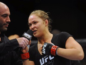 Ronda Rousey speaks following her victory in the bantamweight championship match against Sara McMann at UFC 170 in Las Vegas last February. (Stephen R. Sylvanie/USA TODAY Sports)