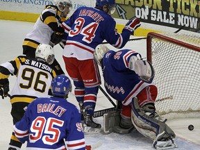 Kingston Frontenacs Spencer Watson, left, and Ryan Kujawinski watch the puck go behind Kitchener Rangers goalie Dawson Carty as Justin Bailey and Max Iafrate look on during Ontario Hockey League action at the Rogers K-Rock Centre on Friday night. (Ian MacAlpine/The Whig-Standard)