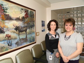 JOHN LAPPA/THE SUDBURY STAR           
Coordinator Judy Latendre-Paquette, left, and primary care nurse Brenda Kirkbride, of the Health Sciences North HAVEN Program, stand in front of a painting by Sudbury artist Greg Maskwa, who has lost many friends to AIDS.