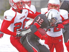 Lorne Park Spartans’ David Clausen (left) makes a tackle on St. Ignatius Falcons’ Lucas Sandberg during their game on Friday at Ron Joyce Stadium in Hamilton. (VERONICA HENRI/Toronto Sun)