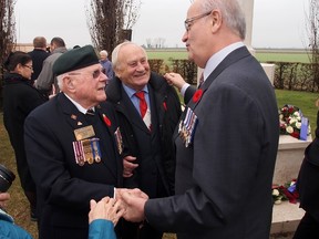 Minister Julian Fantino speaks with Veteran Sheridan Atkinson and local resident Oviglio Monti following a commemorative ceremony at the Villanova Canadian War Cemetery. Mr. Monti was assisted by the Royal Canadian Regiment after being orphaned during the war. (Supplied Photo)