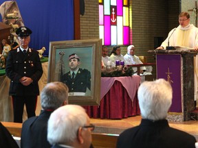 Members of Hamilton's Italian community gathered at St. Anthony of Padua Church on Nov. 29, 2014 for a mass dedicated to the late Cpl. Nathan Cirillo, the Canadian soldier gunned down Oct. 22 while standing guard at the National War Memorial in Ottawa. Rev. Janusz Roginski led the memorial service. (CHRIS DOUCETTE/TORONTO SUN)