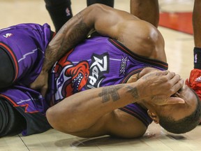 Toronto Raptors guard/forward DeMar DeRozan reacts after getting hurt against the Dallas Mavericks at the ACC in Toronto on Friday November 28, 2014. (DAVE THOMAS/Toronto Sun/QMI Agency)