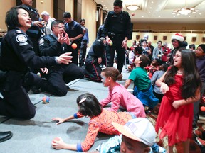 Children and Toronto Police officers has a snowball fight -- with sponge balls -- during the the Rotary Club of Toronto's 85th Christmas party, on Nov. 29, 2014. (Veronica Henri/Toronto Sun)