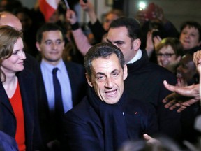 Former French president Nicolas Sarkozy is greeted by well-wishers as he leaves his campaign headquarters after he won the UMP vote for the party's new leader in Paris, Nov. 29, 2014. (GONZALO FUENTES/Reuters)