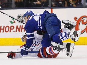 Maple Leafs forward Leo Komarov collides with a Washington Capitals player at the Air Canada Centre on Saturday night. (Stan Behal/Toronto Sun)