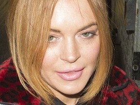 Lindsay Lohan signs autographs for fans as she leaves the Playhouse Theatre after performing on stage in 'Speed-the-Plow'. (WENN.com)