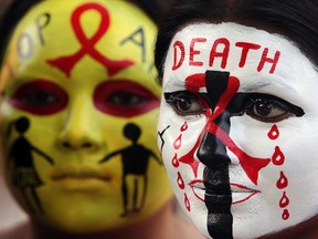Volunteers of National Service Scheme pose with HIV/AIDS awareness messages on their faces during a face painting competition ahead of the World AIDS Day in the northern Indian city of Chandigarh November 29, 2014. World AIDS Day is observed on December 1 every year. (REUTERS/Ajay Verma)