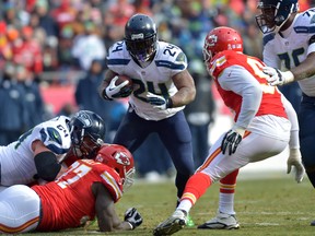 Seattle Seahawks running back Marshawn Lynch (24) runs the ball as Kansas City Chiefs outside linebacker Tamba Hali (91) attempts the tackle during the first half at Arrowhead Stadium on Nov 16, 2014 in Kansas City, MO, USA. (Denny Medley/USA TODAY Sports)