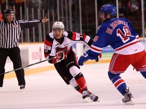 Ottawa 67's forward Jeremiah Addison tries to get by Kitchener's Doug Blaisdell during the first period of Sunday's game between the 67's and Rangers at TD Place. (Chris Hofley/Ottawa Sun)