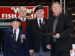 The Sarnia Sting honoured two more veterans Friday night during their game against the Owen Sound Attack as part of the monthly Veterans Way program. From left are veteran Marion Bradley, Veterans Way organizer Greg Burr, John Docherty and Sting president Bill Abercrombie. (TERRY BRIDGE/THE OBSERVER)
