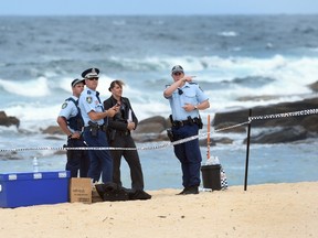 Police organise a search of the sand dunes after children playing at a Sydney beach on November 30, 2014, stumbled across the body of a baby buried under the sand, Australian investigators said, just a week after a newborn was found crying at the bottom of a roadside drain.  New South Wales police said they had established a crime scene at the beach in the eastern Sydney suburb of Maroubra after the grisly discovery on Sunday morning.  AFP PHOTO/William West