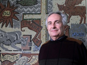 Rev. Drew Strickland, the minister of Chalmers United Church, stands in front of a mosaic in the church hall created by artist Andre Bieler in 1957. (Ian MacAlpine/The Whig-Standard)