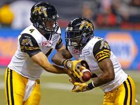 Ti-Cats  #2 Nic Grigsby takes the hand off from quarterback Zach Collaros during second quarter action at the 102nd Canadian Football League Grey Cup championship game between the Calgary Stampeders and the Hamilton Tiger-Cats in Vancouver on Nov. 30, 214. (Al Charest/QMI Agency)