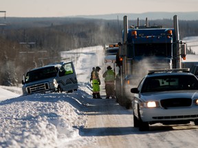 Whitecourt RCMP, fire and EMS respond to the scene of a motor vehicle collision involving an Alberta Correctional Services transport van and a semi-tractor trailer on in the westbound lanes of Highway 43 on Sunday Nov. 30, 2014 in Whitecourt, Alta. 
Adam Dietrich | Whitecourt Star