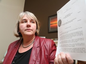 Gino Donato/The Sudbury Star                         
Nicole Desmarais shows off a document of a lawsuit she has filed against the Ministry of Child and Youth Services seeking to have the province cover the cost of  treatment for her adopted son, whom she wants to see get specialized care for two severe mental illnesses.