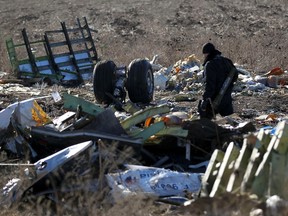 A pro-Russian armed man secures the crash site of the Malaysia Airlines flight MH17 near the village of Hrabove (Grabovo) in Donetsk region, eastern Ukraine, on November 20, 2014. (REUTERS/Antonio Bronic)