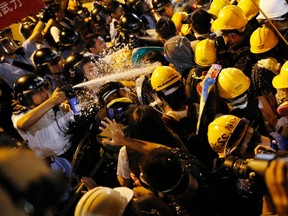 Police use pepper spray during clashes with pro-democracy protesters close to the chief executive office in Hong Kong on November 30, 2014. (REUTERS/Tyrone Siu)