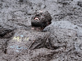 A competitor competes in the Mud Madness race, at Foymore Lodge in Portadown, County Armagh on September 14, 2014. AFP PHOTO / Paul Faith