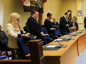 Belleville's new council assembles around the table during Monday's inauguration at city hall. Standing from left: Couns. Kelly McCaw, Egerton Boyce, Jackie Denyes, Mike Graham, chief administrative officer Rick Kester, Mayor Taso Christopher, clerk Matt MacDonald, Couns. Jack Miller, Paul Carr, Garnet Thompson and Mitch Panciuk.