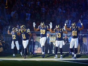 Rams players Stedman Bailey (12), Tavon Austin (11), Jared Cook (89), Chris Givens (13), and Kenny Britt (81) put their hands up to show support for Michael Brown before a game against the Raiders in St. Louis on Sunday, Nov. 30, 2014. (Jeff Curry/USA TODAY Sports)