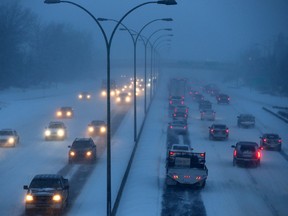 Rush hour traffic makes its way through the snow westbound (right) and eastbound  on Whitemud Drive at 159 St., at around 4:20pm in Edmonton Alta., on Thursday Nov 27, 2014.(TOM BRAID/Edmonton Sun)