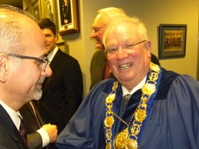 ERNST KUGLIN/The Intelligencer 
Belleville's new mayor Taso Christopher (left) congratulates Quinte West's new mayor Jim Harrison during inauguration ceremonies in Quinte West Monday night.