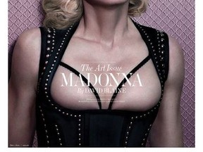 Madonna poses on the December/January cover of Interview magazine. IN a photo spread inside the pop star goes topless.