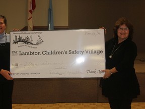 LFA director Debbie Gilliard, right, presents a cheque for $15,000 to Maryanne Buntrock, chair of the Lambton Children's Safety Village committee
