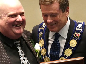 Councillor Rob Ford gets  his declaration of office from Mayor John Tory during the swearing-in ceremony Tuesday December 2, 2014. (Craig Robertson/Toronto Sun)