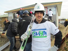 Sarnia Sting player Taylor Dupuis strikes a pose as he and his teammates, as well as team staff, spent Tuesday helping hang siding and drywall at a Habitat for Humanity building site on East Street. (PAUL MORDEN, The Observer_