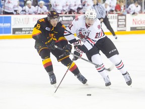 Carter Verhaeghe (21) of the Niagara IceDogs and Chad Heffernan (18) of the Belleville Bulls in OHL action at the Meridian Centre in St. Catharines on Thursday, November 27, 2014.