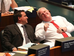 Councillor Giorgio Mammoliti sits next to then mayor Rob Ford at council July 9, 2014. (Veronica Henri/Toronto Sun)