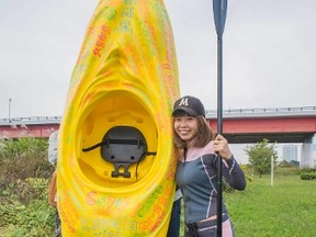 Japanese artist Megumi Igarashi, known as Rokudenashiko, poses with her kayak modeled on her vagina at the Tama river in Tokyo in this October 19, 2013 picture provided by Eigo Shimojo.  REUTERS/Eigo Shimojo/Handout via Reuters