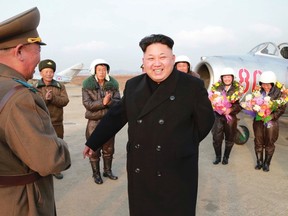 North Korean leader Kim Jong Un smiles as he provides field guidance to the flight drill of female pilots of pursuit planes of the KPA Air and Anti-Air Force in this undated photo released by North Korea's Korean Central News Agency (KCNA) in Pyongyang on November 28, 2014. (REUTERS/KCNA)