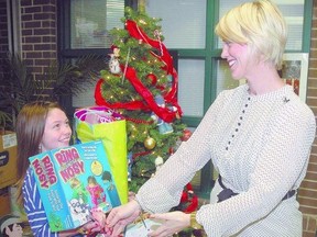 Two years ago, while a student at Forest Park Public School, Emma Chilvers donated her birthday gifts to the school, who in turn passed them along to needy families. Pictured is Emma presenting the gifts to learning support teacher Megan Virtue. On Monday, Chilvers will make a large donation to Violence Against Women, Services Elgin County. (File photo)