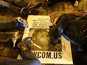 Demonstrators lie down in the middle of the street in protest following the grand jury decision in the Ferguson, Mo., shooting of Michael Brown, in Seattle, Wash., on November 24, 2014. (REUTERS/Jason Redmond)