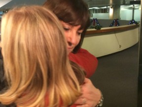 Councillor Maria Augimeri hugs Councillor Frances Nunziata at City Hall on Wednesday, Dec. 3, 2014. (DON PEAT/Toronto Sun)