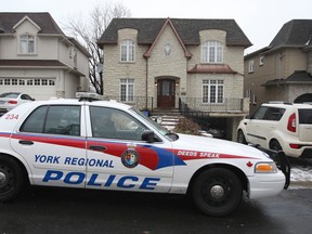 Police outside of the Woodward Ave. home where the home invasion took place. (VERONICA HENRI/Toronto Sun)