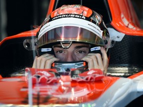 A file photo taken on July  18, 2014 shows Marussia's French driver Jules Bianchi putting on his helmet in the pit during the first practice session ahead of the German Formula One Grand Prix at the Hockenheimring in Hockenheim, Germany. Formula One driver Jules Bianchi has been brought out of an artificial coma and flown to France, his family announced on November 19, 2014 nearly seven weeks after a Japanese Grand Prix crash that caused a critical brain injury.  AFP PHOTO / PATRIK STOLLARZ