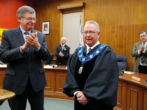 Prince Edward County mayor Robert Quaiff receives his robes and collar from former mayor Peter Mertens during the inaugural meeting of the new Prince Edward County council at Shire Hall, Tuesday, Dec, 2, 2014. 
Emily Mountney-Lessard/Belleville Intelligencer/QMI Agency