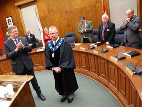 Former mayor Peter Mertens and the incoming Prince Edward County council applaud new mayor Robert Quaiff as he receives his robes and collar Tuesday, Dec. 2, 2014 at Shire Hall. 
Emily Mountney-Lessard/The Intelligencer/QMI Agency
