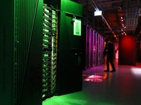 A member of the media films the room with the IBM Blue Gene Q Supercomputer on the launch day for the HBP at the Swiss Federal Institute of Technology (EPFL) in Ecublens, near Lausanne Oct. 7, 2013. REUTERS/Denis Balibouse