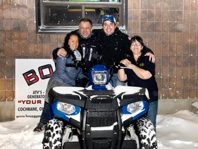 Robert Vezeau sitting on the bike poses with Mr. and Mrs. Gerry Bourque from Bourques auto sales and Jan Todish owner of Thibs, outside of the Tavern last Saturday. Vezeau had just won the 2014 Polaris Industry Sporstman 400 4- wheeler which was  the main contestants prize during Saturday's Moosecall event held at Thib's on Saturday Nov.29th.