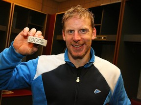 Daniel Alfredsson #11 of the Ottawa Senators holds the puck he used to score his third goal of the game - and 1,000th point of his career- against the Buffalo Sabres at HSBC Arena on October 22, 2010 in Buffalo, New York.  (Photo by Bill Wippert/NHLI via Getty Images)