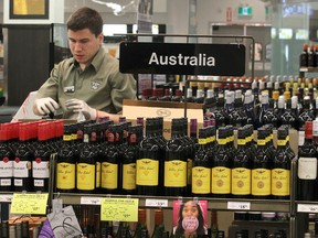 An employee at the Grant Park Liquor Mart stocks shelves earlier this year. Workers have voted 97.2% in favour of going on strike. (Kevin King/Winnipeg Sun file photo)